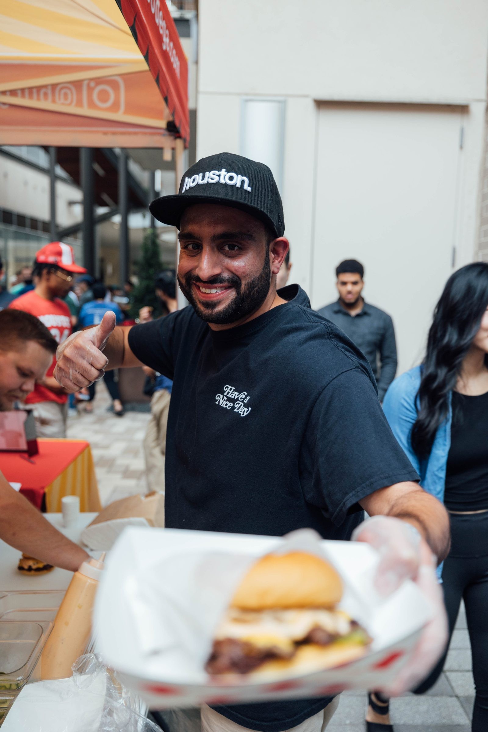 Founder Abbas Dhanani serving a fresh smash burger