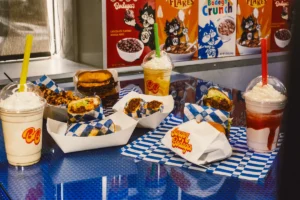 Burger Bodega burgers, fries, stuffed tacos, and milkshakes served on a table.